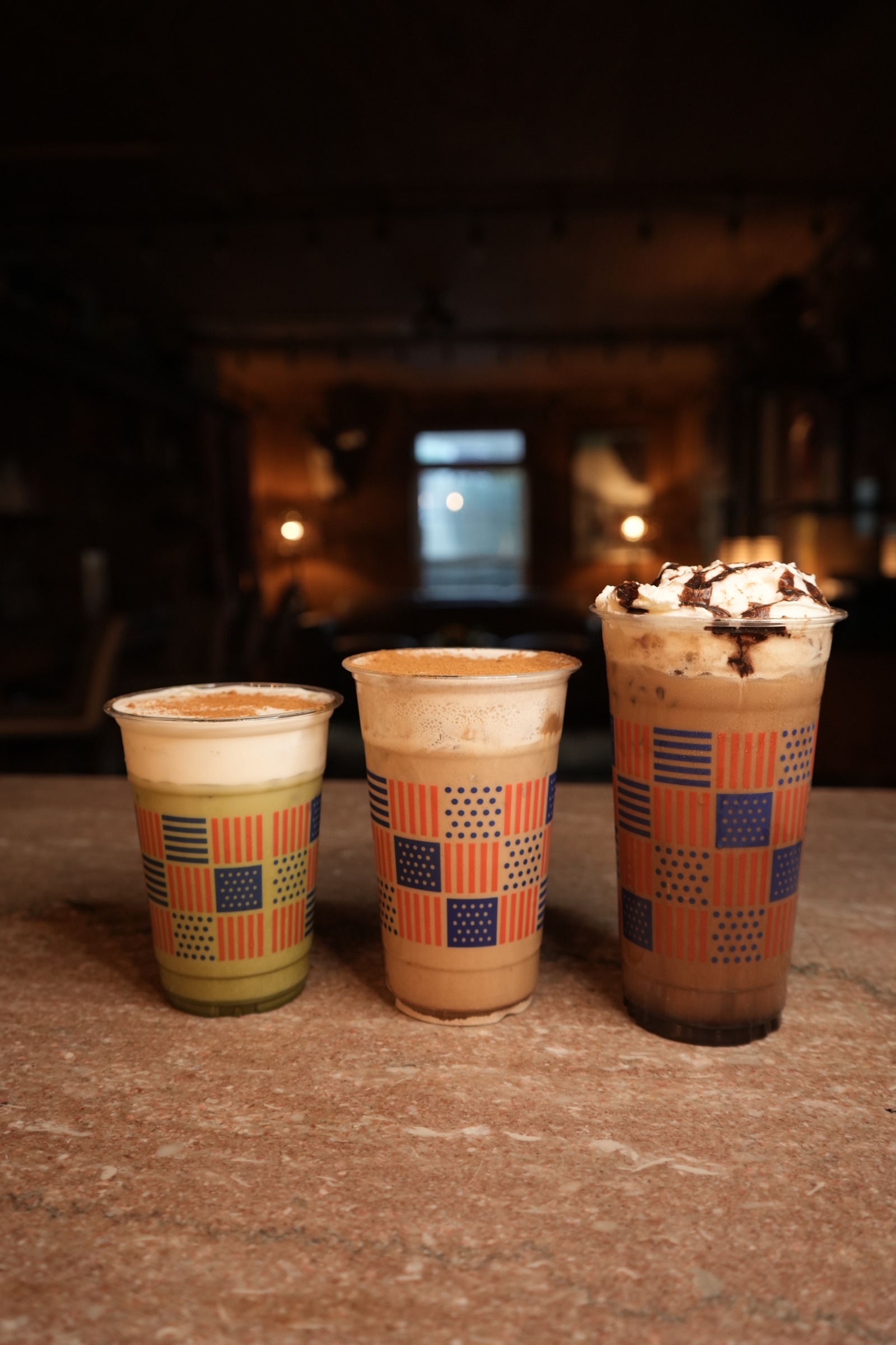 Three iced Coffee Guys drinks on the counter